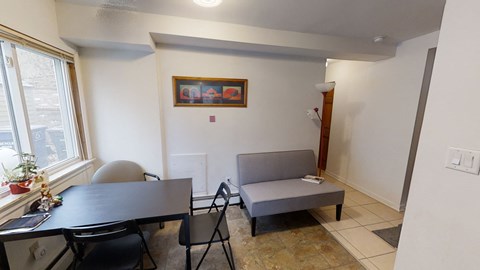 a dining room and living room with a table and a couch